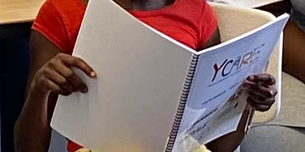 A person holding an open book in their hands.
